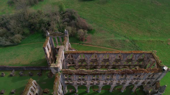 Aerial view looking down over remains of Yorkshire's Rievaulx Abbey historical building ruins, Helms