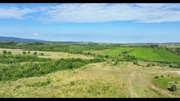 Scenic panoramic landscape of countryside, push in. Green meadows, fields, and pastures