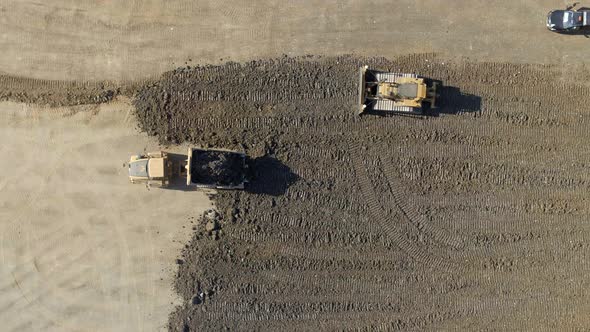 A Lorry Moving Substrate for a Bulldozer to Flatten in Construction