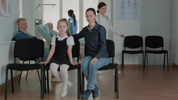 Portrait of Mother and Little Girl in Waiting Room at Clinic