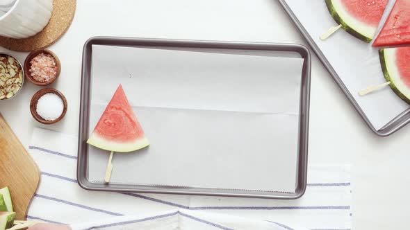 Step by step. Time lapse. Slicing watermelon into wadges to make watermelon ice pops.