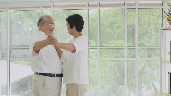 Family concept. Senior couple dancing inside the house. 4k Resolution.