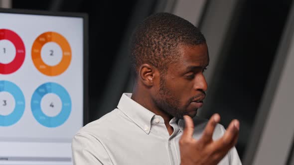 Young man listening to a question from colleagues at a presentation