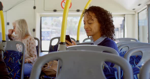 Commuters using and talking on mobile phone while travelling in bus 4k