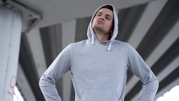 Sporty man stretching neck and arms on street training