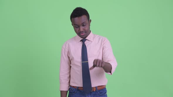 Sad Young African Businessman Giving Thumbs Down