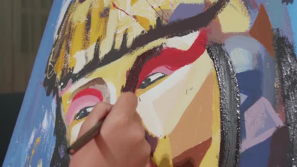 Close Up Of A Boy Holding Paintbrush Mixed Colour And Painting A Girl's Nose On The Canvas