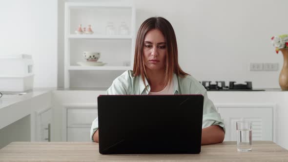 Young Woman Receives Bad News on Her Laptop