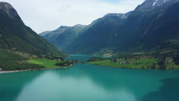 Amazing panoramic view of Oldevatnet glacial lake surrounded by tall mountains - Norway aerial