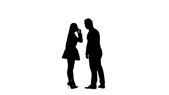 Guy and Girl Are Arguing, They Have a Scandal. Silhouette. White Background. Slow Motion