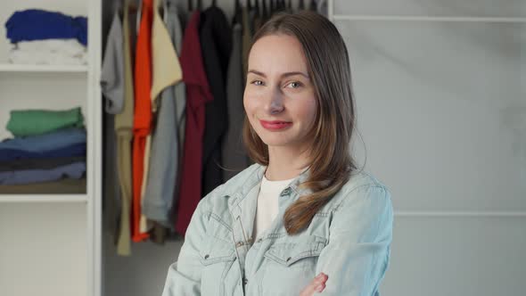 Portrait of a Woman Who Stands Against the Background of a Large Wardrobe a Wardrobe with Stylish