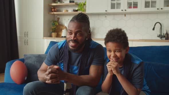 Joyful African Family of American Football Fans Watching Game Live on Tv at Home