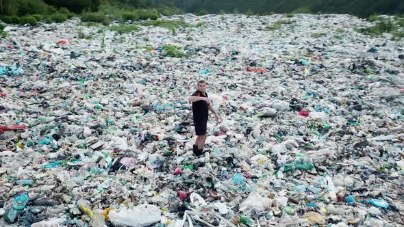 A man at a landfill. The concept of environmental pollution and environmental catastrophe.