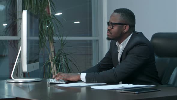 Handsome Afro-american Businessman Working and Typing on Laptop in the Office