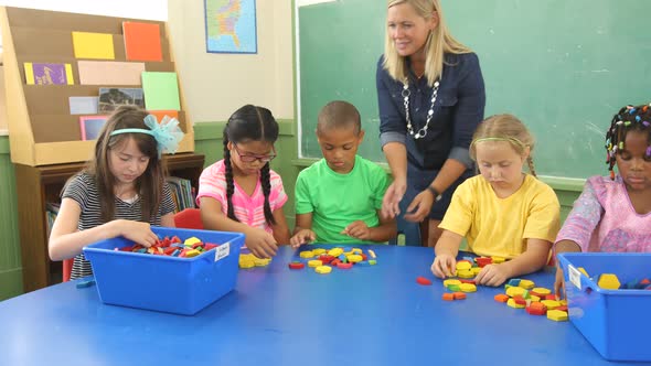 Students in school classroom experiment with shape blocks