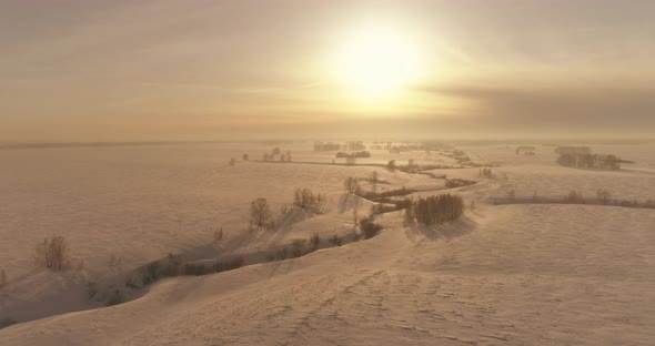 Aerial View of Cold Winter Landscape Arctic Field Trees Covered with Frost Snow Ice River and Sun