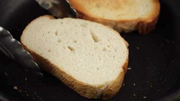 Cooking toasts sliced bread in a frying pan