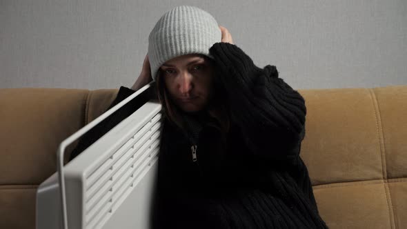 Sick Woman Feels Cold and Dresses Warmly Sitting Near Heater