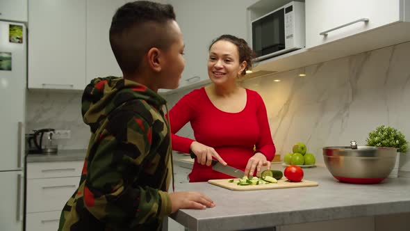 Mom Giving Bowl Whisk to Son He Starting to Whip Ingredients Indoors