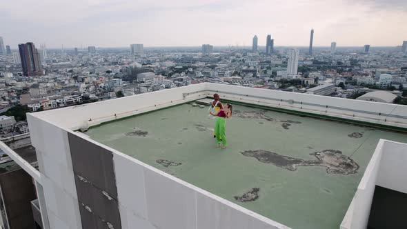 Drone Shot Of Fashion Models Staring To Dance On City Rooftop