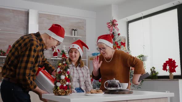 Happy Family Enjoying Winter Holiday Celebrating Christmas Season Standing at Table