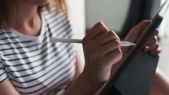 Talented Artist Draws on Tablet Computer in Room Closeup