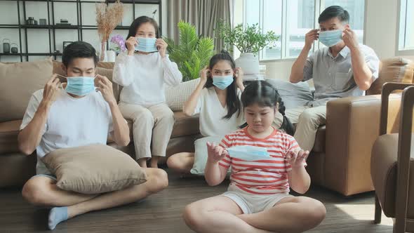 portrait of asian family multi generation wearing surgical facial mask stay quarantine