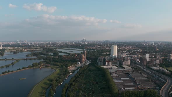 Descending drone shot of London city skyline from Tottenham Hale Walthamstow reservoirs