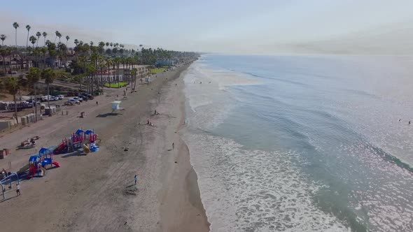 sunny summer day at Oceanside beach, California. Aerial view