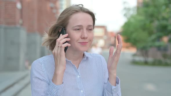 Portrait of Woman Arguing While Talking on Phone Outdoor