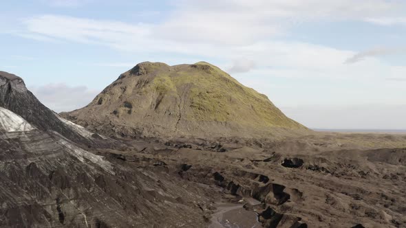 Drone Flying Next to a Glacier following the Ashy Trail of a Volcano