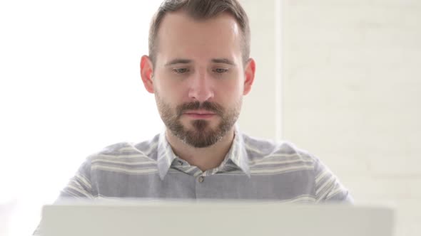 Man Smiling and Looking at Camera at Work