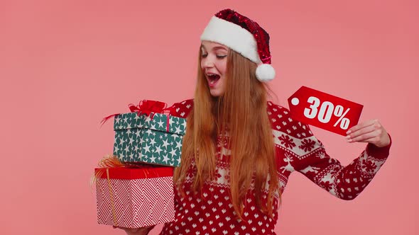 Girl in Christmas Sweater Showing Gift Boxes and 30 Percent Discount Inscriptions Banner Text Note