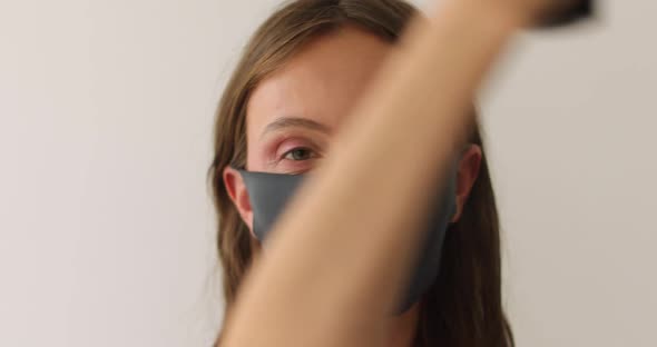 Woman in Protective Mask Splashes with Makeup