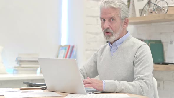 Amazed Old Man Feeling Impressed at Workplace