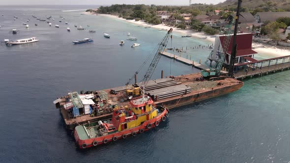 Aerial water pipe construction work platform loading cargo freight at pier of GIli Trawangan,Indones