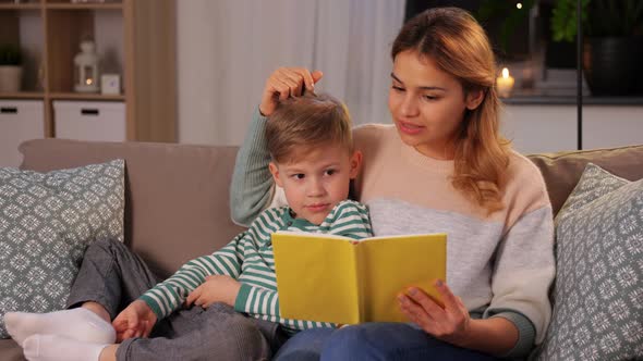 Happy Mother and Son Reading Book Sofa at Home