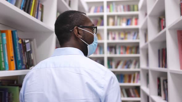 University Library: African American Man in a Mask During Quarantine Covid-19 Prepares for the Exam