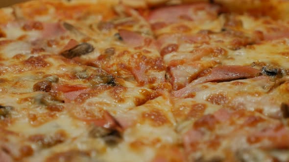 Cheese bacon and chamignons spreaded on tasty baked pizza surface 4K 2160p 30fps UHD panning  video 