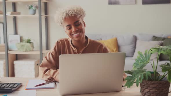 Smiling Young Interracial Business Woman Work Distant on Laptop