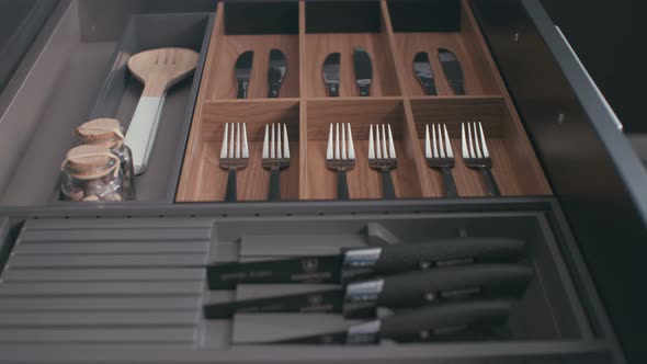 Tracking shot of a kitchen utensils cabinet in a luxury kitchen