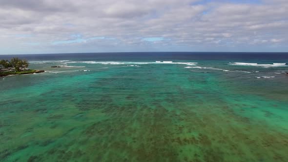 Aerial shot of turquoise Hawaiian waters of Kawela Bay Beech Park near the Turtle Bay Resort.