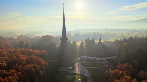 Aerial drone view of the Peri-Sapanta Monastery at sunrise, Romania. Main church and a building