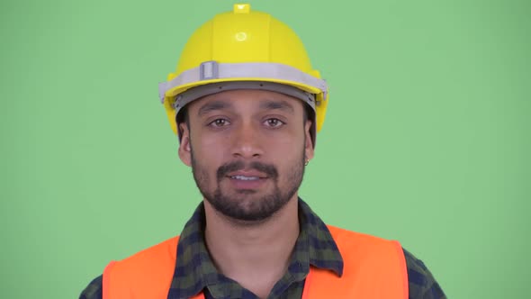 Face of Serious Young Bearded Persian Man Construction Worker Nodding Head No