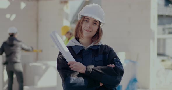 Confident Female Architect Holding Blueprint