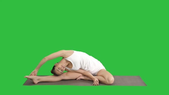 Beautiful young woman wearing white clothing doing yoga