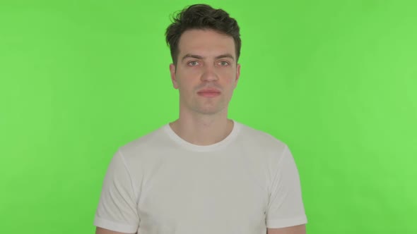 Young Man Smiling on Green Background