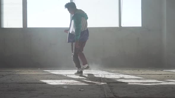 Skillful Young Man Dancing in an Abandoned Building. Hip Hop Culture. Rehearsal. Contemporary