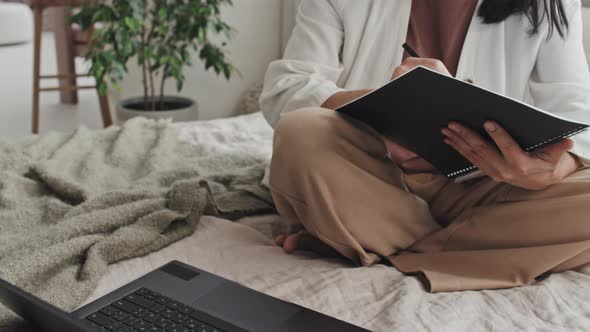 Female Freelancer Working on Bed