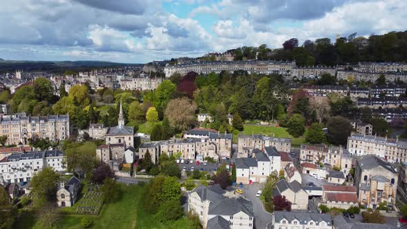 Rising aerial looking overa residential area in Bath, Somerset, including the stunning Camden cresen